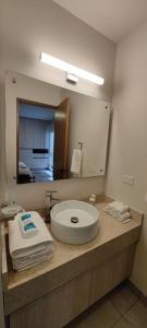 a bathroom with a toilet on a counter with a mirror at Casa Acento by Cosmos Homes in Querétaro