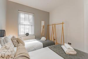 - une chambre avec 2 lits et une fenêtre dans l'établissement Cosy & Stylish Apmt w/ Fast Wifi, à Londres