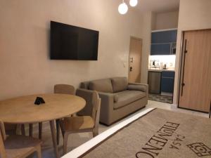 a living room with a couch and a table at Confortable Studio in the heart of Mexico in Mexico City +12 photos