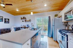 a kitchen with a sink and a refrigerator at River Time Retreat in Carson +19 photos
