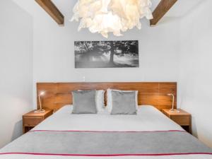 a bedroom with a bed and a chandelier at OM 686 URBAN LOFTS Narvarte in Mexico City
