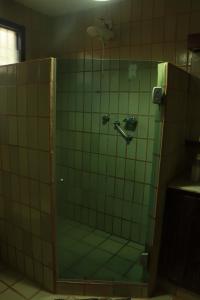 a shower in a bathroom with green tiles at Albergue Cultural São Salomão in Recife +31 photos