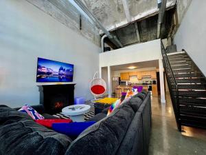 a living room with a couch and a fireplace at Kings Island Loft with Brewery, River, and Bike Trail in Maineville