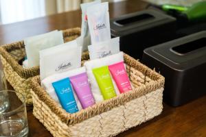 a basket filled with different colored towels on a table at Isabella Boutique Hotel in San Pedro Sula