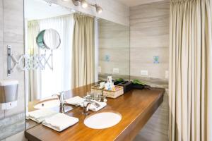 a bathroom with a sink and a mirror at Isabella Boutique Hotel in San Pedro Sula