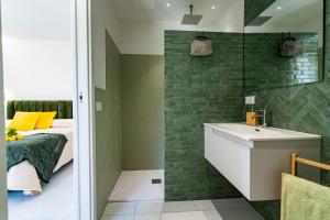 a small bathroom with a bed and a sink at Villa Talia in Sorrento +43 photos