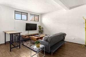 a living room with a couch and a flat screen tv at MS Moderna Suite Arcos Hercules HD1 in Laborcillas