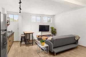 a living room with a couch and a kitchen at MS Moderna Suite Arcos Hercules HD1 in Laborcillas +14 photos