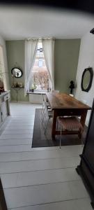 a dining room with a wooden table and chairs at Townhouse Center Arnhem in Arnhem