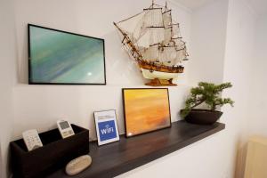 a shelf with a pirate ship on a wall at Luna 22 in Poreč