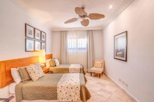 a bedroom with two beds and a ceiling fan at FISHING LODGE, INFINITY POOL, VISTAS A LA BAHIA in Punta Cana +17 photos