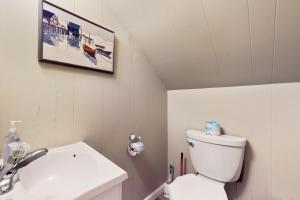 a bathroom with a white toilet and a sink at Town of Rehoboth Beach --- 206 Norfolk St in Rehoboth Beach +14 photos