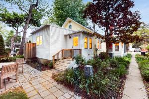 a small white house with a porch and a bench at Town of Rehoboth Beach --- 206 Norfolk St in Rehoboth Beach