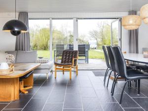 a living room with a table and chairs at Holiday home Hemmet XI in Hemmet