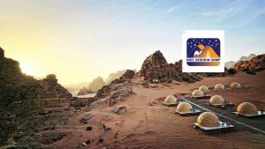 a group of domes in a desert with a sign at Nael Bedouin camp in Wadi Rum