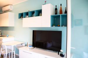 a living room with a large tv and a table at DiBa House 46 in San Vito Chietino