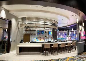 a lobby with a bar with stools at Muckleshoot Casino Resort in Auburn