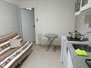 a small kitchen with a table and a sink at Studio Arenas in Arequipa