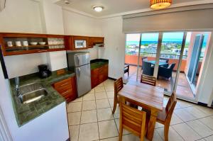 a kitchen with a table and a dining room at Torre Mar Galapagos Boutique Suites in Puerto Ayora