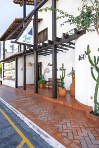a building with a brick walkway in front of it at Pousada Porto Fino in Cabo Frio