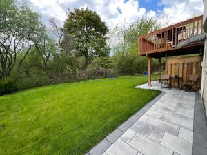 a backyard with a deck and a lawn at Cozy, brand-new, 2BDR,walkout apt, free parking in Richmond Hill