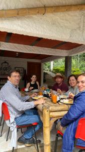 a group of people sitting around a wooden table at La Greca - Casa de Paz in San Agustín
