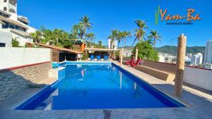 a swimming pool on the roof of a building at Suites Acapulco Yamba in Acapulco