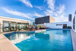 a swimming pool on top of a building at Hotel Grand Chancellor Brisbane in Brisbane