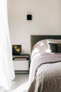 a bedroom with a bed and a side table with a picture at Boutique B&B Bovien in Amsterdam