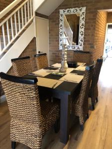 a dining room with a table and chairs at Sailz Villas in Yarrawonga