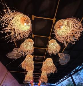 a group of chandeliers hanging from a ceiling at Heaven Guesthouse in Pakse