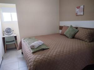 a bedroom with a bed with a pillow on it at Urban Home in Guatemala