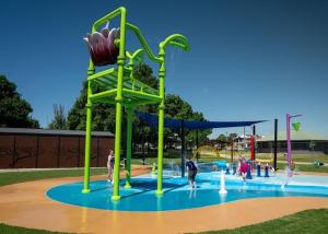 a playground with people playing in a water park at Sailz Villas in Yarrawonga