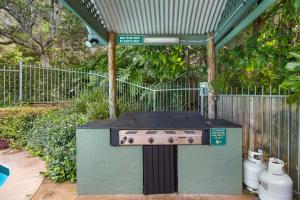 a box with a sign on it next to a fence at Little Diggers in Coffs Harbour