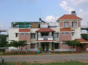a large building with aventh floor at Palmyrah Tenements in Mysore