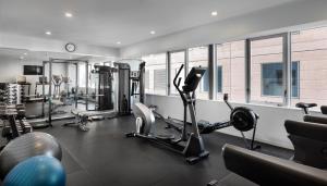 a gym with several treadmills and cardio machines at Rydges Auckland in Auckland