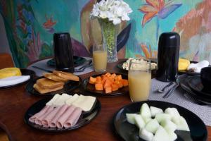 a table topped with plates of food and glasses of orange juice at Milagres de Minas in São Miguel dos Milagres