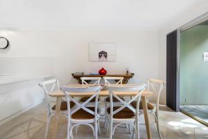 a dining room with a table and chairs at Oceanique in Coffs Harbour