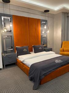 a bedroom with a large bed with a wooden headboard at Royal Suit Premium in Istanbul
