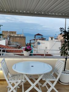 a white table and two chairs on a balcony at The Sorabellas in Gaeta