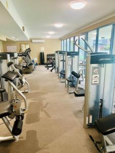 a gym with a row of treadms and machines at Swell Resort Burleigh Heads in Gold Coast