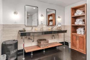 a bathroom with a sink and a mirror at Skyline Suite with Penthouse & Rooftop Deck in Nashville