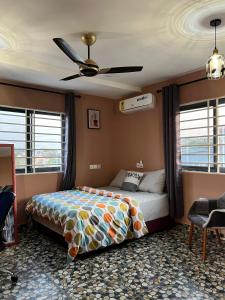 - une chambre avec un lit et un ventilateur de plafond dans l'établissement Renda Residence, à Deabenekrom