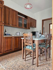 a kitchen with a table and two chairs and a counter at La Casa di Nonna Gina in Alba