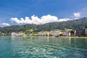 a yellow circle on the water near a city at Marina Studio Bregenz - See & City in Bregenz