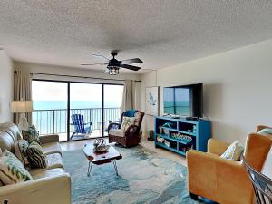 a living room with a view of the ocean at Ocean Sands 1002 in St Pete Beach