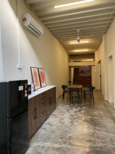 a kitchen with a black refrigerator and a table at Aayu Beach St - George Town Penang in George Town