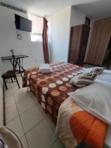 Postel nebo postele na pokoji v ubytování Hotel Residencial C´BASTIAN
