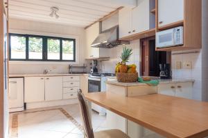 a kitchen with a table with fruit on it at Casa Sol Búzios in Armacao dos Buzios +10 photos
