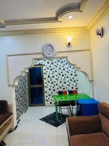 ein Wohnzimmer mit einem Tisch und einem Teller an der Wand in der Unterkunft RÉSIDENCE ACHIKA INELIA in Bobo-Dioulasso